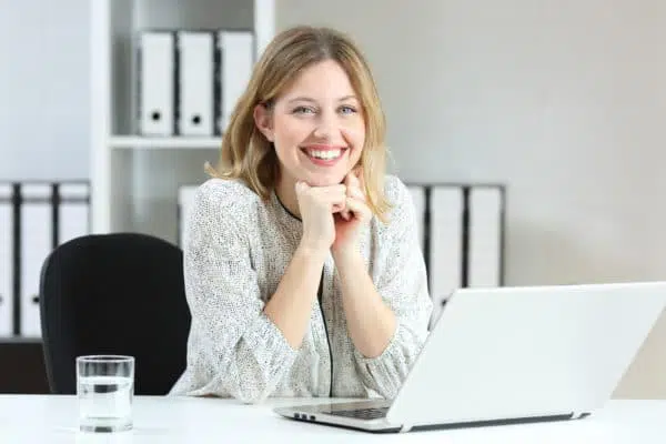 Employee smiling while using dashboards by CTSI-Global