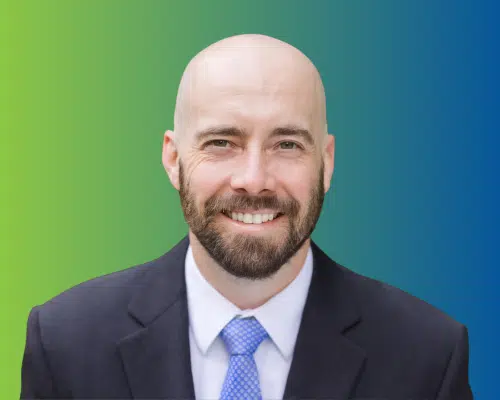 Spencer's headshot on a green-to-blue gradient background.